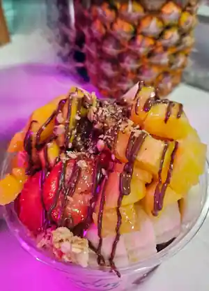 Customer photo — açaí bowl with pineapple and chocolate drizzle